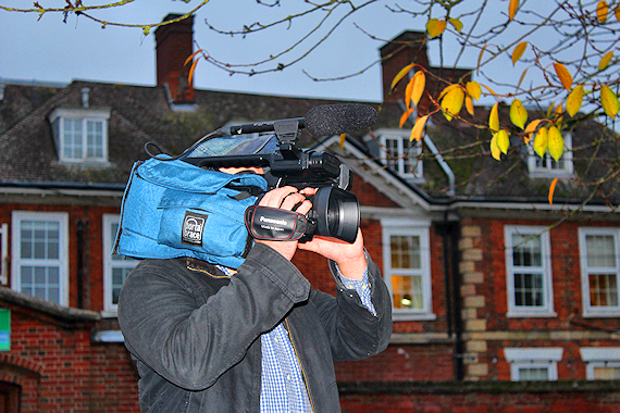 A Lundscapes cameraman filming with shrubbery behind